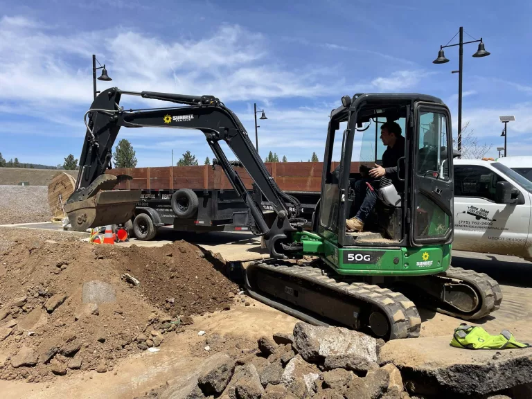 Making a dirt, rock, and sand delivery with track loader